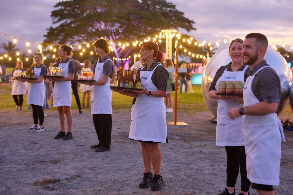 Nu Nu service team carrying drink trays at a dusk event at The Mill