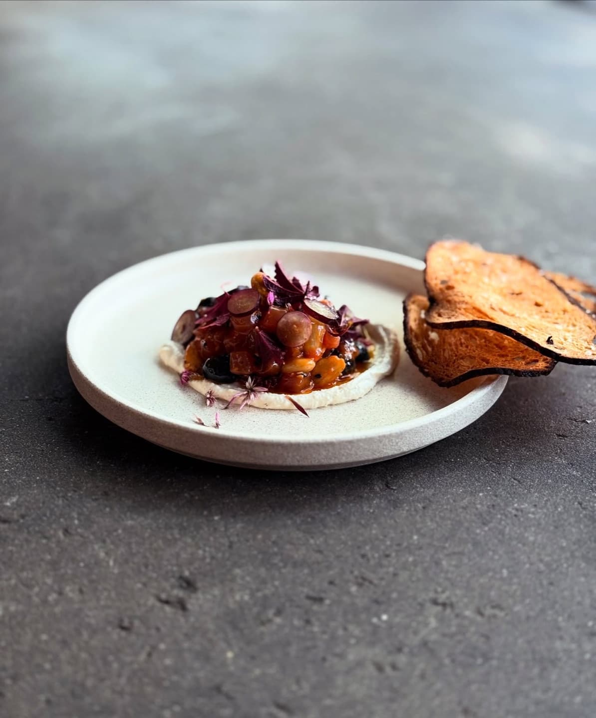 Raw yellowfin tuna with smoked almond, grapes and red pepper, a crisp on the side