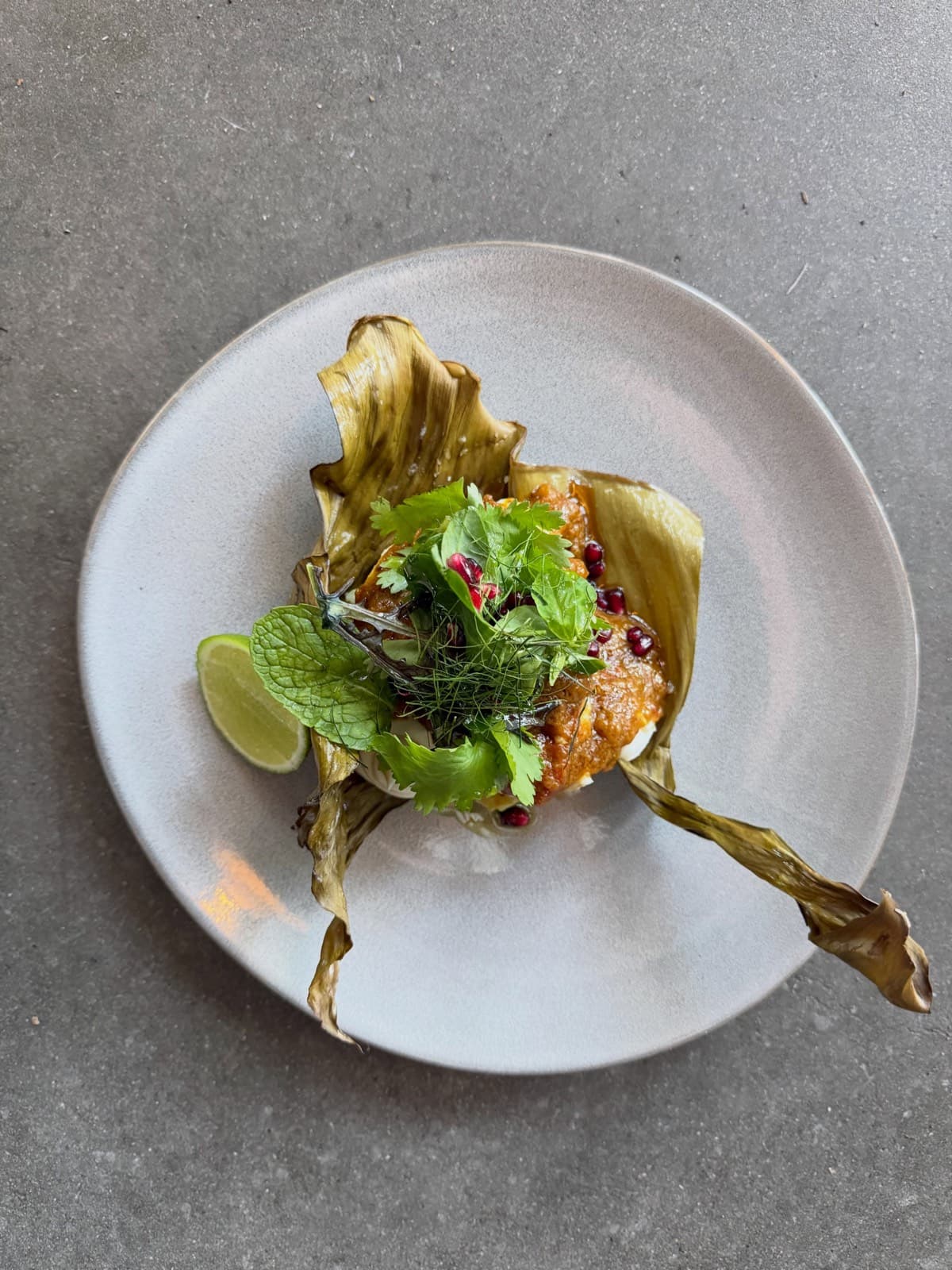 Local reef fish roasted in a charred banana leaf with mango masala, herbs and lime