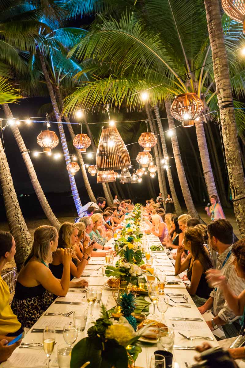 Dinner guests at long table on Palm Cove beach